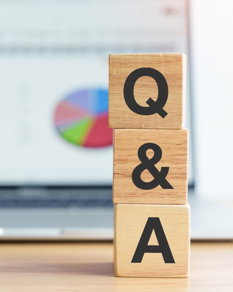 Questions and Ask wood block and laptop computer with graph background. FAQ, frequency asked questions, Answer, Q and A, Information, Communication, questionnaire and Brainstorming Concepts